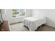 Minimalist bedroom showcasing a neatly made bed with a clean and bright window view at 4643 Darla Ct, Indianapolis, IN 46239