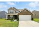 Charming two-story home with a brick and vinyl exterior, well-manicured lawn, and attached two-car garage at 4643 Darla Ct, Indianapolis, IN 46239