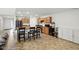 Spacious kitchen and dining area featuring wooden cabinets, a center island with seating, and a view of the living room at 4643 Darla Ct, Indianapolis, IN 46239