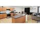 Spacious kitchen featuring stainless steel appliances, an island with seating, and an open view to the living room at 4643 Darla Ct, Indianapolis, IN 46239