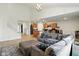 Open concept living room showcasing a staircase, sofa, fireplace, kitchen, and eating area at 4643 Darla Ct, Indianapolis, IN 46239