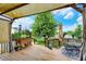 Back deck with an outdoor dining set, lovely landscaping, scenic views and privacy at 564 Gainesway N Dr, Greenwood, IN 46142