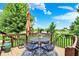 Back deck with a table, chairs, and umbrella with a beautiful scenic view of the lush backyard at 564 Gainesway N Dr, Greenwood, IN 46142