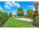 Expansive backyard with a basketball court, lush landscaping, and a glimpse of the serene lakefront, perfect for outdoor enjoyment at 564 Gainesway N Dr, Greenwood, IN 46142