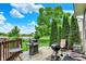Backyard featuring a grassy yard, patio, grill, mature trees, and a calming view of the pond at 564 Gainesway N Dr, Greenwood, IN 46142