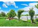 Lakeside backyard featuring a swing and fire pit, offering a serene and inviting outdoor space for relaxation and entertainment at 564 Gainesway N Dr, Greenwood, IN 46142