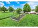 Large backyard with garden, lush lawn, and lake views, a perfect blend of nature and outdoor living at 564 Gainesway N Dr, Greenwood, IN 46142