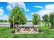 Backyard featuring a lakeside fire pit with seating, offering a cozy outdoor space for gatherings and enjoying scenic views at 564 Gainesway N Dr, Greenwood, IN 46142