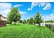 Lush backyard featuring a spacious lawn and lake access, perfect for outdoor recreation and relaxation by the water at 564 Gainesway N Dr, Greenwood, IN 46142