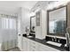 Elegant bathroom with dual sinks, black countertops, and white cabinetry at 564 Gainesway N Dr, Greenwood, IN 46142