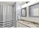 Bright bathroom featuring double sinks, granite counters, modern fixtures, and a shower with tub at 564 Gainesway N Dr, Greenwood, IN 46142