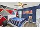 Stylish bedroom featuring a modern bed, fan, and uniquely painted walls at 564 Gainesway N Dr, Greenwood, IN 46142