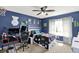 Comfortable bedroom featuring desk, bed, ceiling fan, and blue walls at 564 Gainesway N Dr, Greenwood, IN 46142