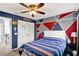 Cozy bedroom featuring blue accent wall, ceiling fan, and double door closet at 564 Gainesway N Dr, Greenwood, IN 46142