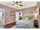 Bedroom with ceiling fan, large bed, and mirrored closet doors at 564 Gainesway N Dr, Greenwood, IN 46142