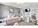 Comfortable bedroom with a trundle bed, patterned wallpaper, and neutral colors at 564 Gainesway N Dr, Greenwood, IN 46142