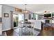The dining area features a wood table with seating, light fixture and a view of the living room at 564 Gainesway N Dr, Greenwood, IN 46142