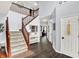 Inviting foyer showcasing staircase, hardwood floors, and neutral decor at 564 Gainesway N Dr, Greenwood, IN 46142