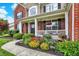 Charming front porch with colorful flowers and plants that provide a welcoming entrance at 564 Gainesway N Dr, Greenwood, IN 46142