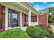 Charming front porch with colorful flowers and plants that provide a welcoming entrance to the home at 564 Gainesway N Dr, Greenwood, IN 46142