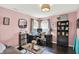 Charming home office features a modern desk, comfortable chair, shelving and lovely pink walls at 564 Gainesway N Dr, Greenwood, IN 46142