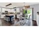 Bright kitchen features white cabinets, an island with bar seating, and a dining area with sliding doors at 564 Gainesway N Dr, Greenwood, IN 46142