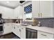 Well-designed kitchen features stainless steel appliances, white cabinets, and stylish backsplash at 564 Gainesway N Dr, Greenwood, IN 46142