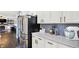 Well-lit kitchen with stainless steel appliances, white cabinets, and ample counter space at 564 Gainesway N Dr, Greenwood, IN 46142