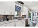 Bright kitchen with white cabinets, stainless steel appliances, and quartz countertops at 564 Gainesway N Dr, Greenwood, IN 46142