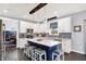 Modern kitchen with a center island, white cabinets, and stylish dark blue backsplash tiles at 564 Gainesway N Dr, Greenwood, IN 46142