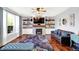 Living room with fireplace, TV, built-in shelving, a large window, and comfortable couches at 564 Gainesway N Dr, Greenwood, IN 46142