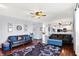 Cozy living room with dark wood floors, dark couches, and an open view to the kitchen and dining area at 564 Gainesway N Dr, Greenwood, IN 46142