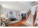 Spacious living room with hardwood floors, comfortable seating, and an open layout leading to the dining area at 564 Gainesway N Dr, Greenwood, IN 46142