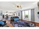Spacious living room with dark wood floors, a comfortable couch, and a large window with natural light at 564 Gainesway N Dr, Greenwood, IN 46142