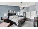 Stylish main bedroom with dark wood furniture, cool color palette, and elegant accents at 564 Gainesway N Dr, Greenwood, IN 46142