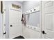 Welcoming mudroom with convenient coat hooks, beadboard trim, and stylish 