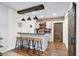 Basement wet bar features a rustic wood beam, brick backsplash, and seating for four at 564 Gainesway N Dr, Greenwood, IN 46142