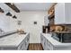 Wet bar featuring marble countertops, shaker cabinets, and a brick backsplash wall at 564 Gainesway N Dr, Greenwood, IN 46142