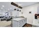 Wet bar with marble countertop, storage cabinets, and access to the living room at 564 Gainesway N Dr, Greenwood, IN 46142