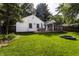 A charming backyard with a deck, screened in porch and mature trees at 5736 Primrose Ave, Indianapolis, IN 46220