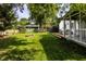 Well-maintained backyard with a lush green lawn, fire pit, shed and cozy seating on a deck at 5736 Primrose Ave, Indianapolis, IN 46220