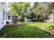 Large backyard with a fire pit, detached shed and a deck with an umbrella and seating at 5736 Primrose Ave, Indianapolis, IN 46220