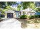 Charming home featuring a stone and vinyl exterior, inviting curb appeal, attached garage, and manicured front lawn at 5736 Primrose Ave, Indianapolis, IN 46220