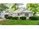 Attractive single Gathering home with stone and vinyl siding, manicured bushes, and a well maintained green lawn at 5736 Primrose Ave, Indianapolis, IN 46220