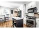 Functional kitchen featuring stainless steel appliances, kitchen island, and wood floors at 5736 Primrose Ave, Indianapolis, IN 46220