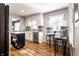 Bright kitchen featuring an island, stainless steel appliances, white cabinets and wood flooring at 5736 Primrose Ave, Indianapolis, IN 46220