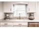 Close up of kitchen counter, sink, and window, showcasing modern finishes and natural light at 5736 Primrose Ave, Indianapolis, IN 46220