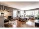Inviting living room with a large sofa, hardwood floors, a fireplace, and plenty of natural light from the windows at 5736 Primrose Ave, Indianapolis, IN 46220