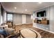 Bright living room with hardwood floors, neutral walls, and a TV, creating a comfortable and stylish living area at 5736 Primrose Ave, Indianapolis, IN 46220