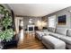 Spacious living room features a gray sofa, fireplace, hardwood floors, and neutral wall paint creating a welcoming atmosphere at 5736 Primrose Ave, Indianapolis, IN 46220